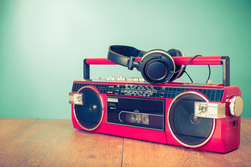 Old retro red stereo radio cassette recorder and headphones