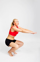 Young woman squating.