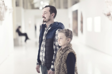 Glad father and daughter enjoying expositions