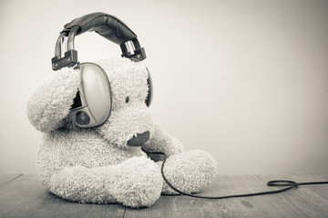 Teddy Bear with retro headphones. Vintage old style sepia photo