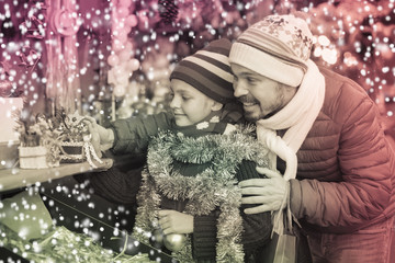 Little girl with dad buying decorations for Xmas