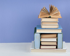 Open book, hardback colorful books on wooden table. Back to school. Copy space for text. Education...