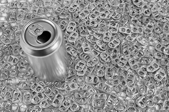 Soda can on aluminum pull rings background