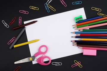 Education or Back To School concept. Stationery on a black background view from the top or flat lay.