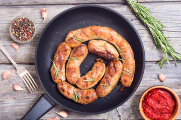 Homemade grilled sausages in pan