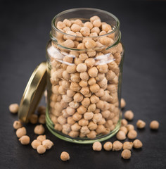 Rustic slate slab with dried Chickpeas, selective focus