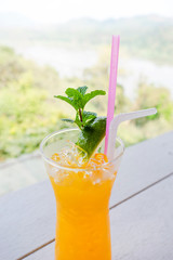 A glass of orange Juice on a table
