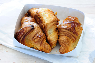 fresh baked croissant on wooden table