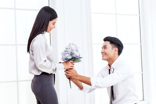 Man Giving A Bouquet Of Flowers For Woman