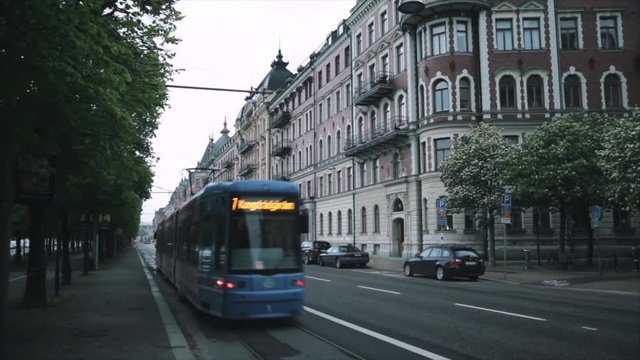 Stockholm, Sweden. A tram travels along the street with cars