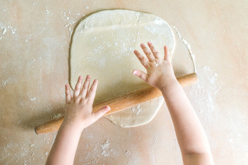 Fototapeta premium Children's hands rolled dough