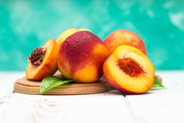 a lot of fresh peaches on a white table