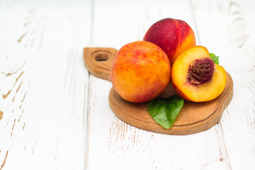 a lot of fresh peaches on a white table