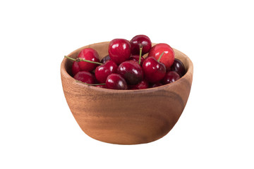Red cherries in wooden bowl isolated on white background with clipping path.