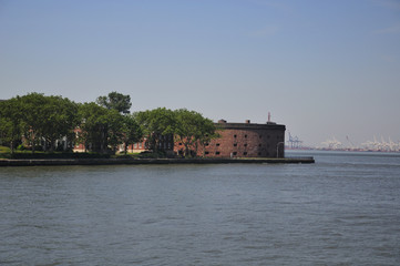 Fototapeta na wymiar Castle Williams on Governors Island national park in Manhattan in New York City, New york on a sunny summer day on the hudson river.