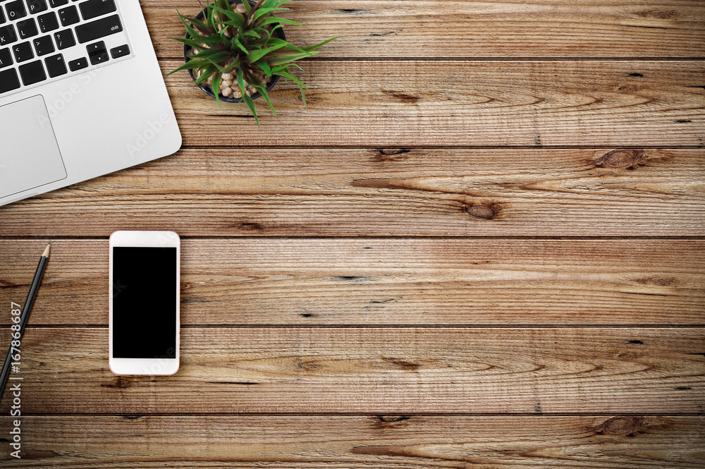 Poster modern workplace with notebook and smartphone copy space on wood background. top view. flat lay styl