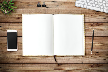 Top view of blank paper page on wood background office desk and different objects. Minimal flat lay style