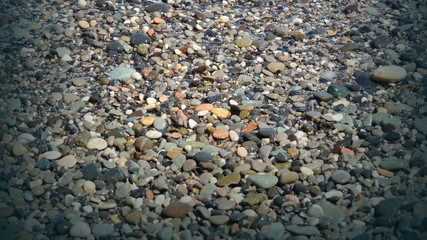Colored pebbles background in vignette.