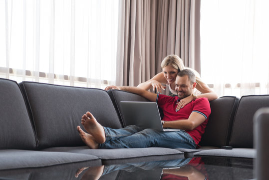couple using laptop at home