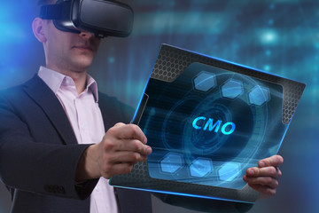 Business, Technology, Internet and network concept. Young businessman working on a virtual screen of the future and sees the inscription: CMO