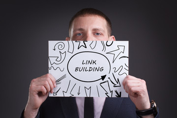 The concept of business, technology, the Internet and the network. Young businessman showing inscription: Link building