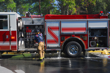 fire truck in residential area with woods on fire