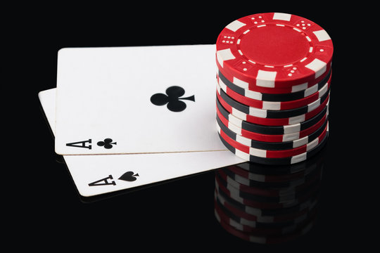 Two aces on poker cards and chip count on them