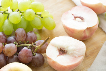 Peaches and grapes on the table. Closeup.