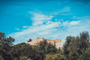 Fototapeta premium Old Greek ruins in background with wide blue sky
