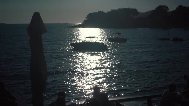 A silhouette of motor boat at sunset