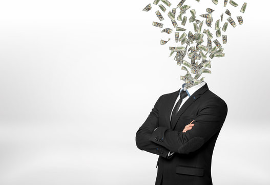 A businessman with forded hands and many dollar bills flying out in place of his head.