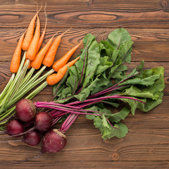 fresh young beets  and carrots on wooden background, top view - 167876433