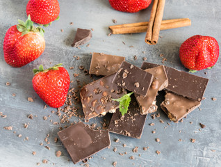 Dairy and bitter chocolate with strawberries and mint leaves