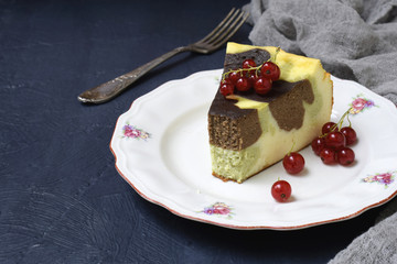 Homemade marble cheesecake with cream cheese, chocolate and tea matcha on a dark background. Copy space. Photographing with natural light