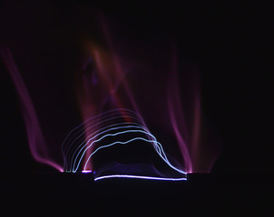 Electric arc between two electrodes seen on a black background.