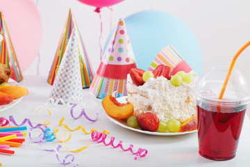 Birthday celebration with cake and colorful balloons