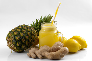 Juicing raw fruits and vegetables and juice extractor recipes concept with pineapple, lemon and...
