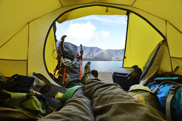 Traveler lying down in the tent with segara anak lake view
