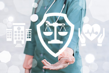 Healthcare Compiance Insurance Hospital Work concept. Doctor offers shield scales icon on a virtual...