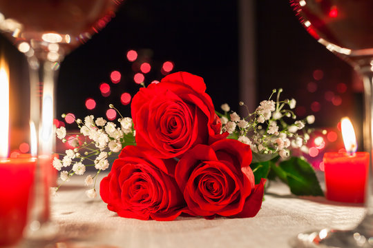 Red roses on a restaurant table. Romantic dinning, and valentines day concept.  