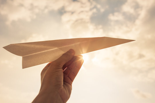 Travel, ideas, inspiration, vision, , Hand holding paper airplane in the sky.