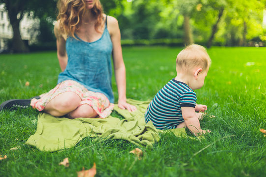 Mother with baby in the park on summer day