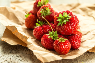 Ripe red strawberries on wooden table