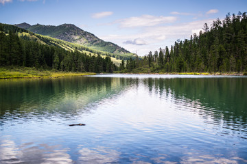mountain lake in front of mountain range, national park in Altai republic, Siberia, Russia