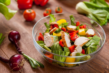 chicken salad bowl on kitchen table, balanced diet