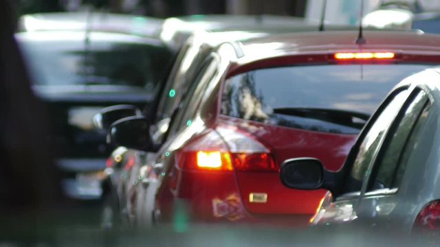 Traffic Jam in the city, big avenue / residential / business area. Cars, vehicles, motorcycles & pedestrians. Dusk. Blurred 