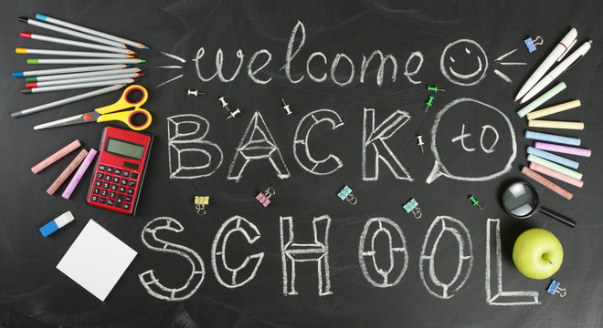 "Back to school" handwritten with school supplies on a black background - Powered by Adobe