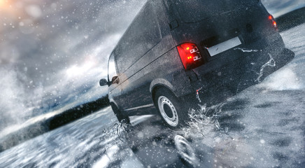 Fast Van driving through the Rain on wet Road