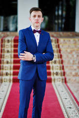 Portrait of an intelligent and handsome young man dressed in tuxedo posing on the red carpet. © AS Photo Family