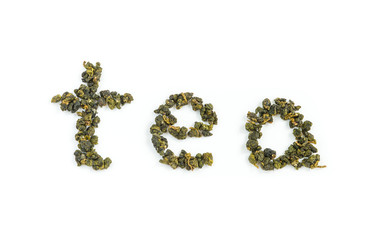 Fresh Tieguanyin Oolong tea leaves arranged in English letters as 
